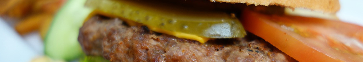 Eating American (Traditional) Burger Greek Hot Dog at Leo's Coney Island restaurant in Roseville, MI.